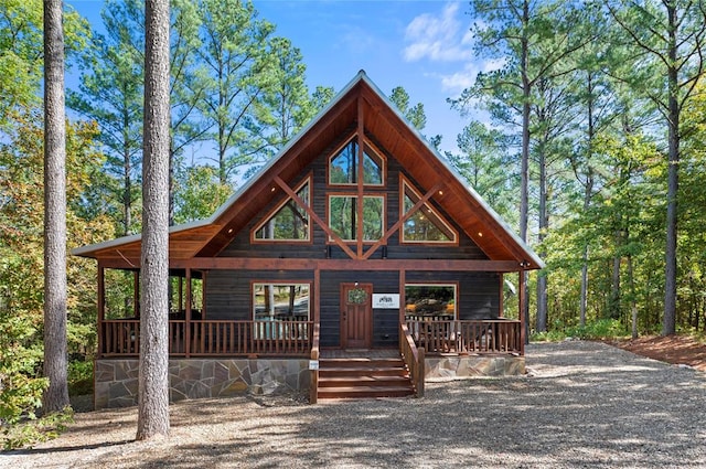 log-style house featuring covered porch