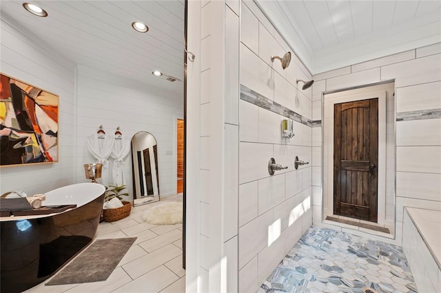 bathroom featuring crown molding, independent shower and bath, and tile walls