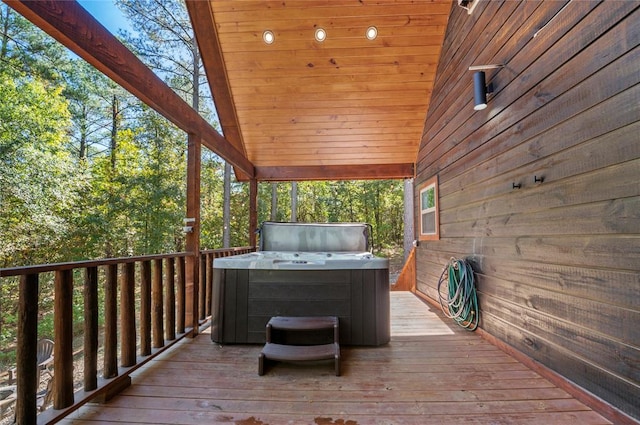 wooden terrace featuring a hot tub