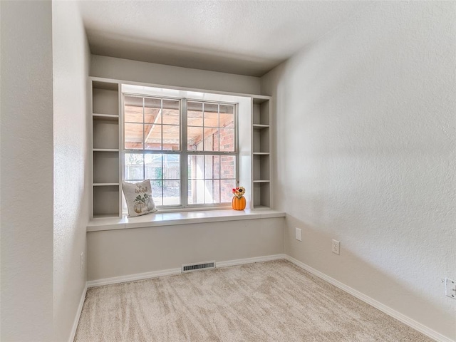 empty room featuring light carpet