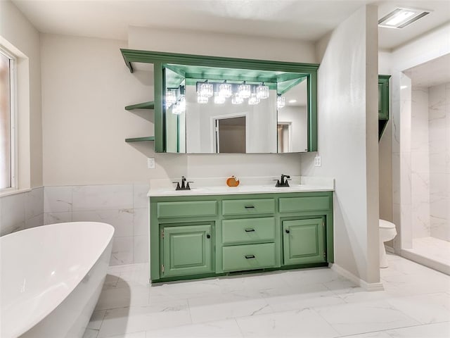 full bathroom with vanity, toilet, tile walls, and independent shower and bath