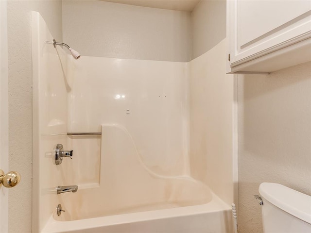 bathroom with toilet and shower / washtub combination