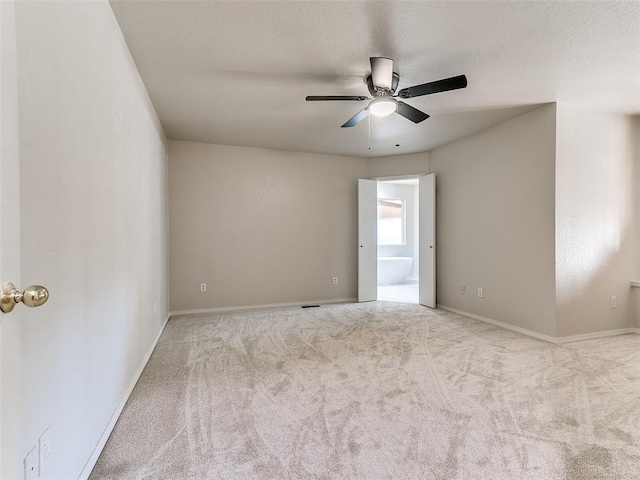 carpeted empty room with ceiling fan