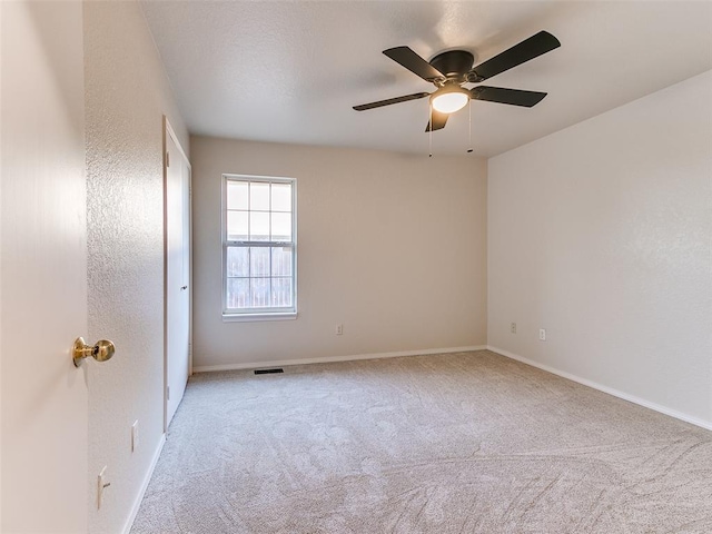 carpeted empty room with ceiling fan