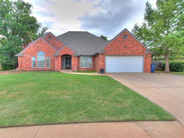 view of front of house with a garage and a front lawn