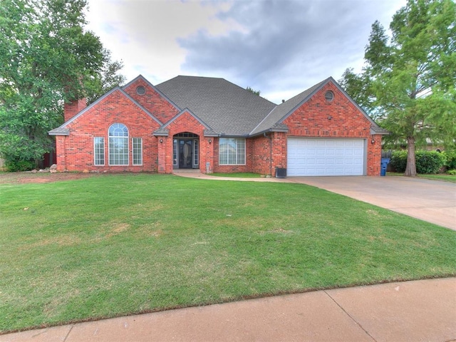 view of front of house with a front yard and a garage