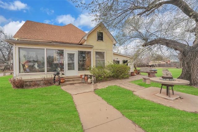 rear view of house with a yard and a patio area