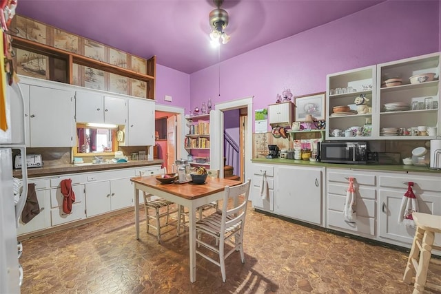 kitchen with white cabinetry and ceiling fan