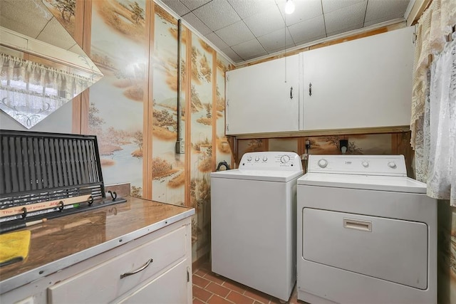 laundry room featuring cabinets and washer and dryer