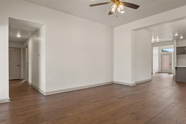 empty room with dark hardwood / wood-style flooring and ceiling fan