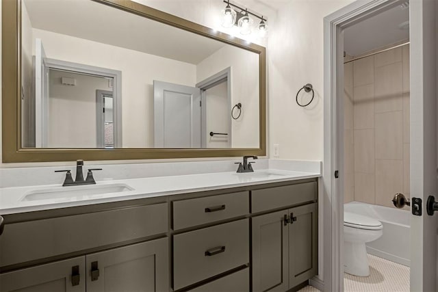 full bathroom with tile patterned floors, tiled shower / bath combo, toilet, and vanity