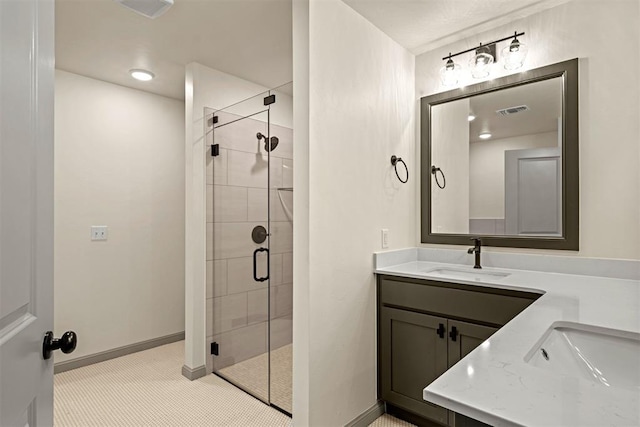 bathroom with a shower with door and vanity