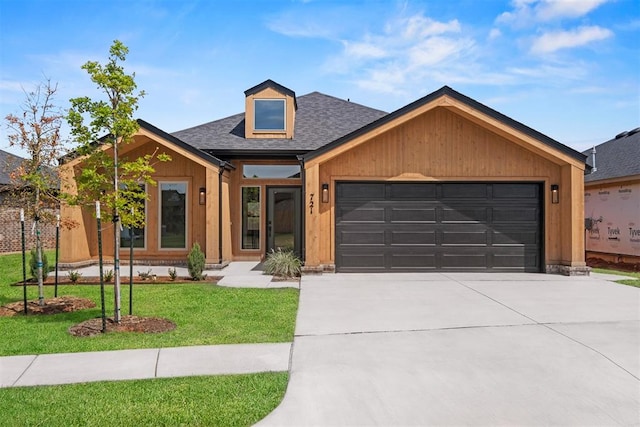 view of front facade with a garage and a front lawn