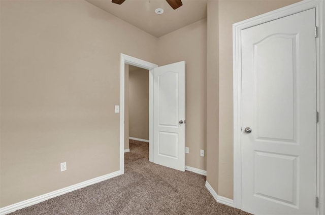 unfurnished bedroom featuring light carpet and ceiling fan