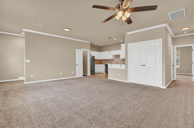 unfurnished living room with light carpet, ceiling fan, and ornamental molding