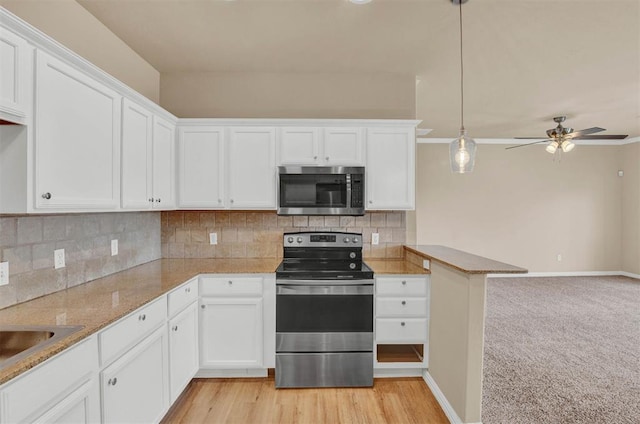 kitchen with light wood-type flooring, stainless steel appliances, ceiling fan, decorative light fixtures, and white cabinetry