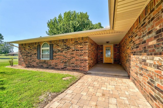 doorway to property with a yard