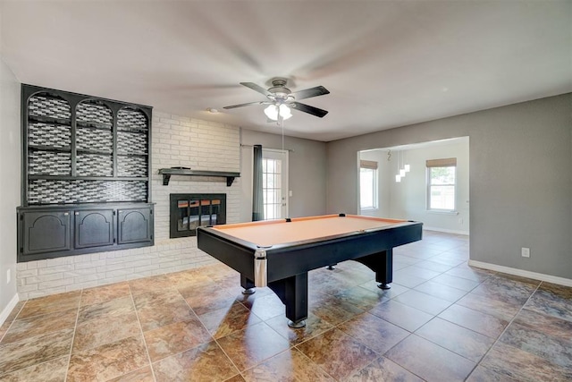 rec room with a brick fireplace, ceiling fan, and billiards