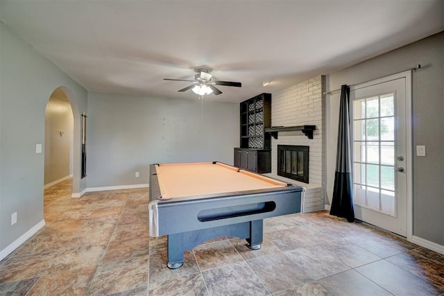 playroom with ceiling fan, a fireplace, and billiards