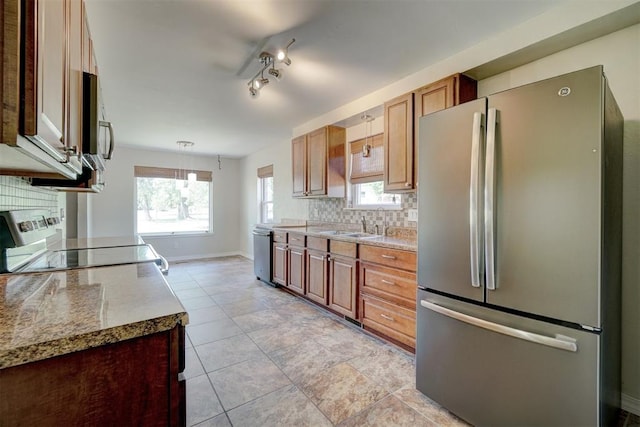 kitchen featuring backsplash, plenty of natural light, sink, and stainless steel appliances