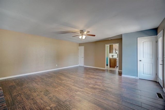 unfurnished room with dark hardwood / wood-style flooring and ceiling fan