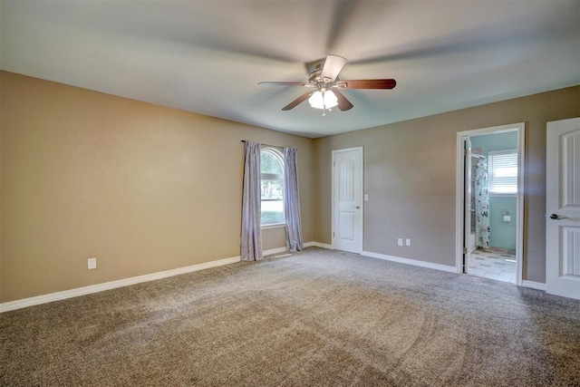 carpeted empty room featuring ceiling fan