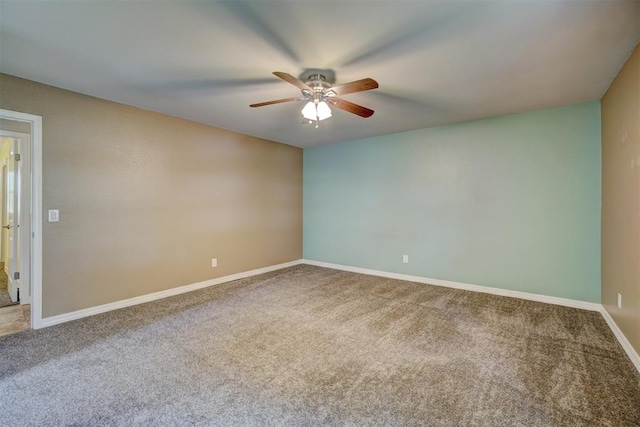 carpeted spare room featuring ceiling fan