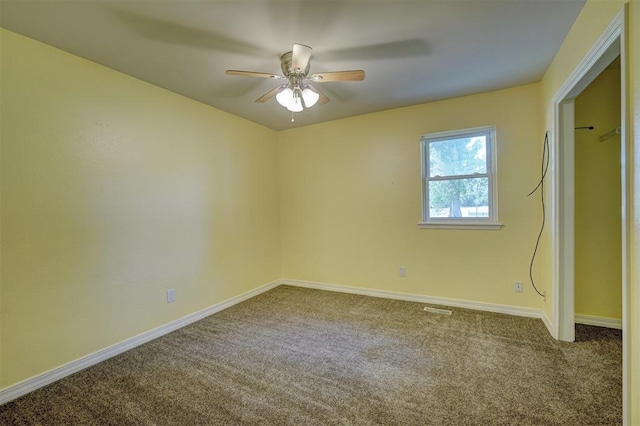 spare room featuring carpet flooring and ceiling fan