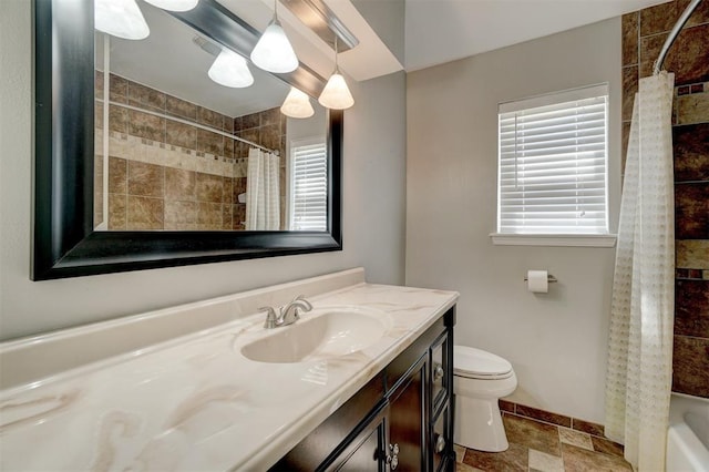 full bathroom featuring vanity, shower / bath combo, and toilet