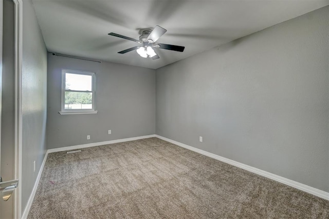 spare room with ceiling fan and carpet floors