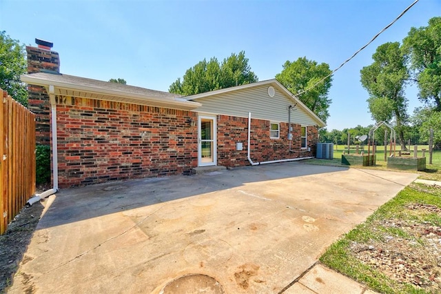 rear view of property featuring central AC unit