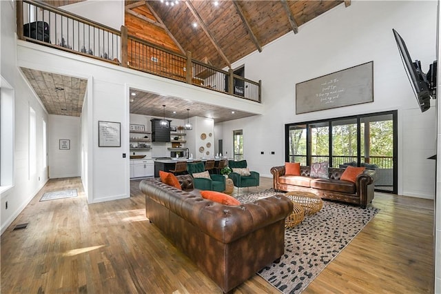 living room featuring hardwood / wood-style floors, high vaulted ceiling, and wood ceiling