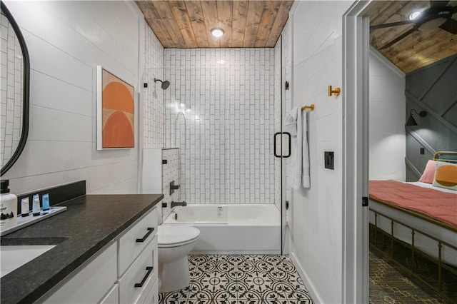 full bathroom featuring vanity, wooden walls, tiled shower / bath combo, toilet, and wood ceiling