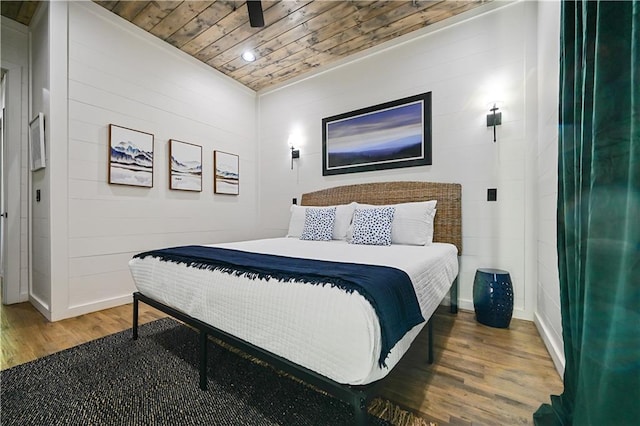 bedroom featuring dark hardwood / wood-style flooring and wooden ceiling