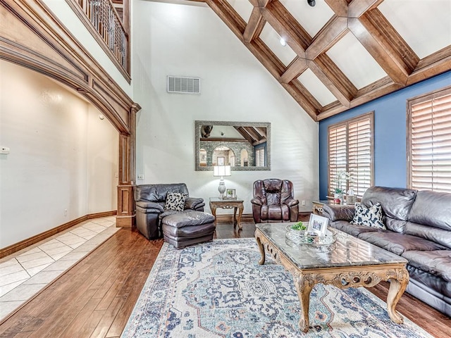 living room featuring hardwood / wood-style flooring, beamed ceiling, and coffered ceiling