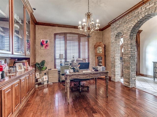 office featuring an inviting chandelier, plenty of natural light, dark wood-type flooring, and crown molding