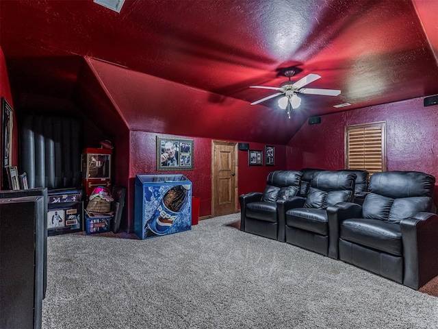 home theater room featuring carpet flooring, ceiling fan, a textured ceiling, and vaulted ceiling