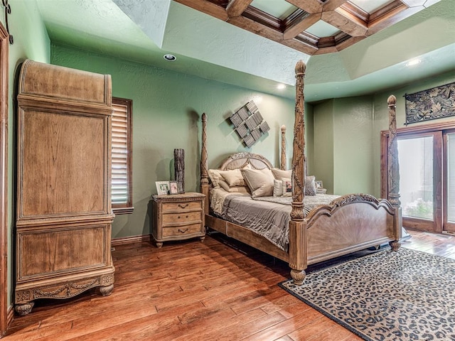 bedroom with beamed ceiling, wood-type flooring, and coffered ceiling