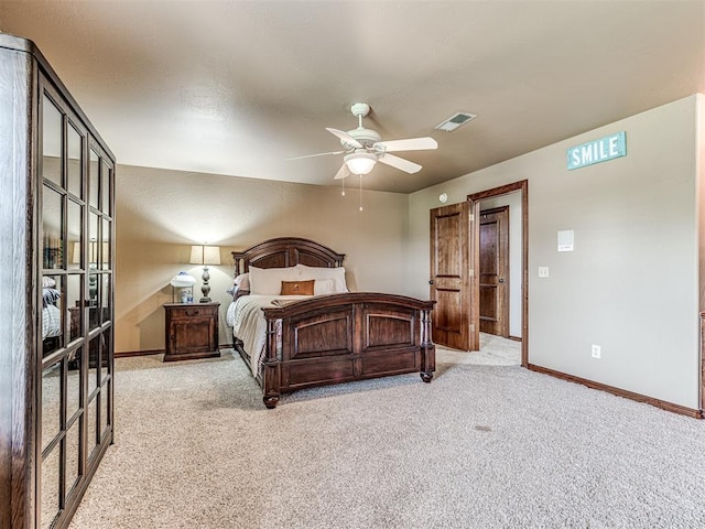 bedroom with ceiling fan and light carpet