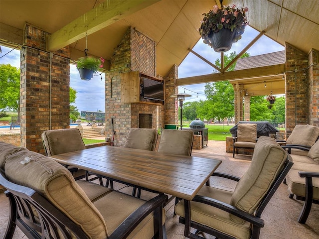 view of patio with an outdoor brick fireplace