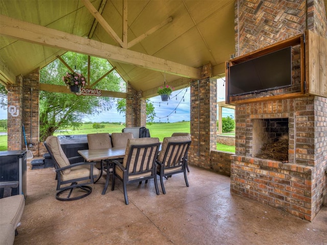 view of patio with a gazebo and an outdoor brick fireplace