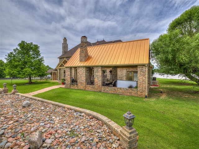 rear view of house featuring a lawn