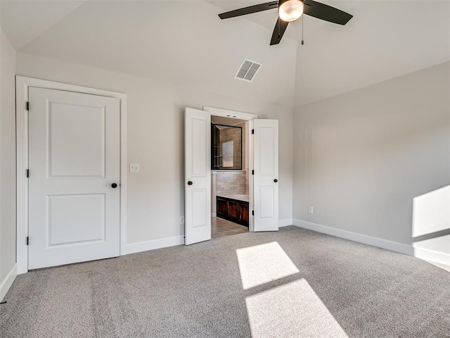 unfurnished bedroom with high vaulted ceiling, ceiling fan, light carpet, and connected bathroom