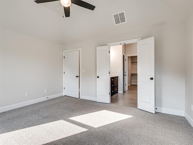 unfurnished bedroom with ceiling fan and light carpet