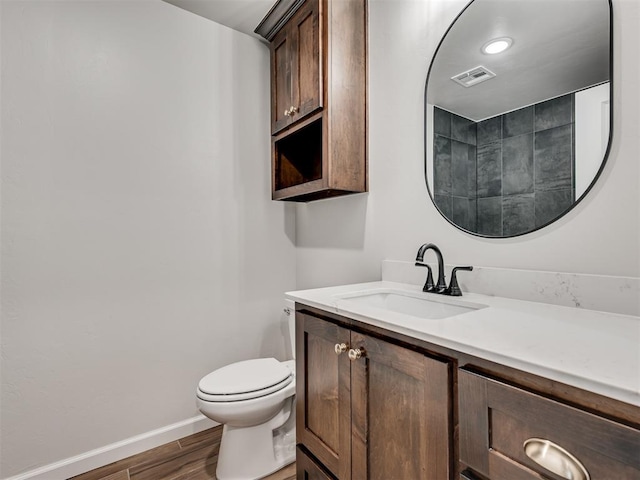 bathroom featuring hardwood / wood-style floors, vanity, and toilet