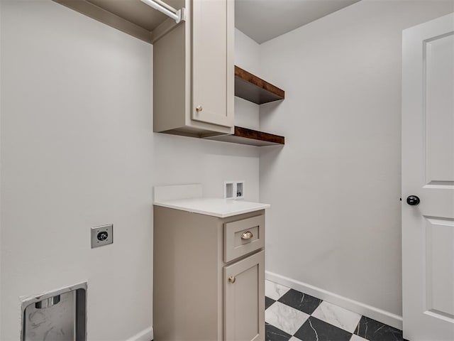 clothes washing area featuring cabinets, hookup for a washing machine, and electric dryer hookup