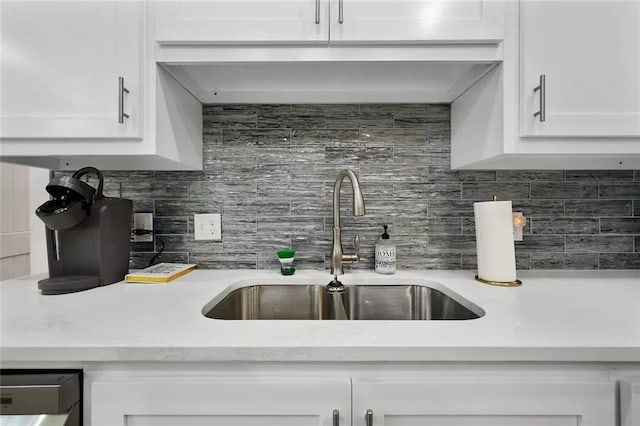 kitchen with white cabinetry, sink, and decorative backsplash