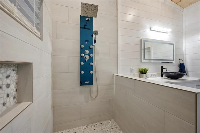 bathroom featuring sink and a tile shower