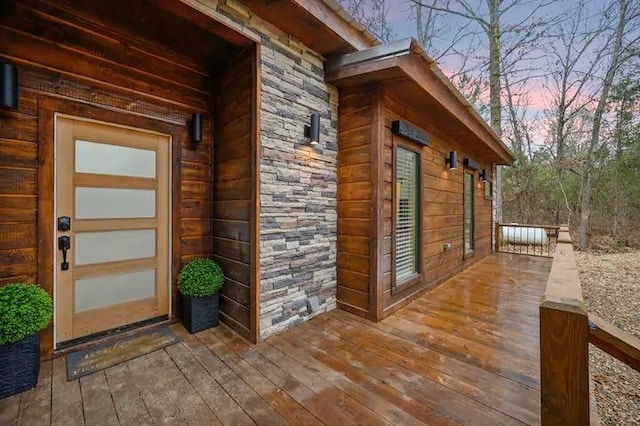 property exterior at dusk featuring a deck