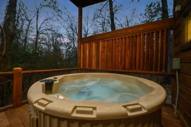 wooden terrace featuring a hot tub